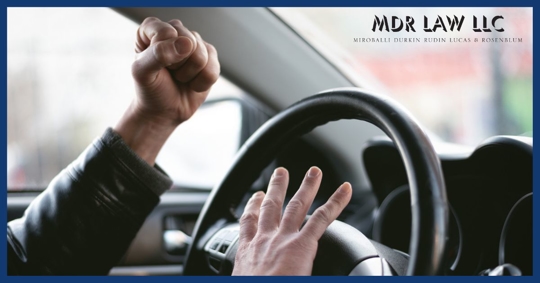 Frustrated man honking the horn of his vehicle