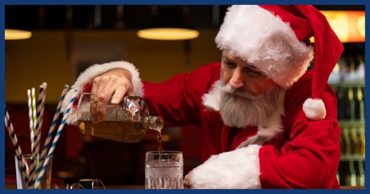 man in Santa costume pouring himself a drink