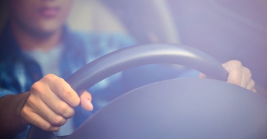 teen driver with hands on wheel